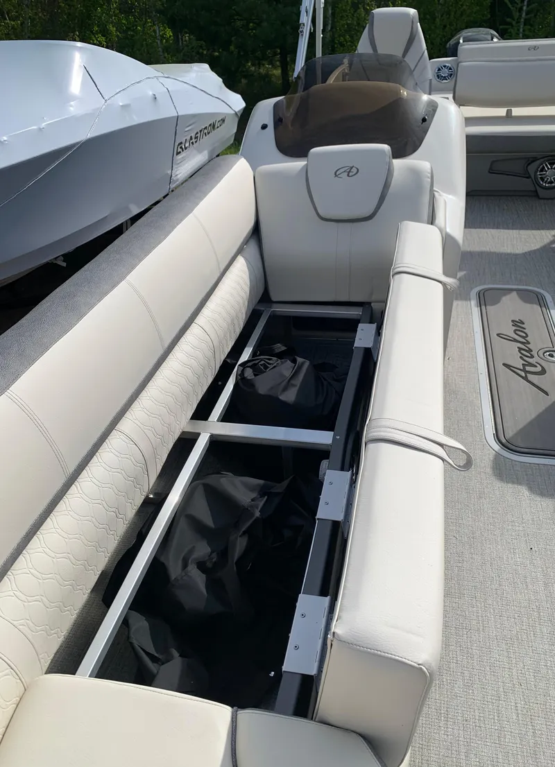 Slide: The Image of 2023 Avalon Catalina VRL 25' Tri-Toon boat with open storage compartment. - 19