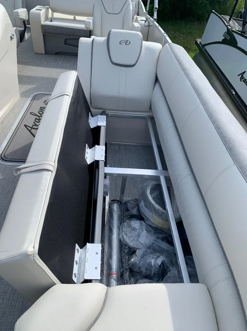 Slide: The Image of 2023 Avalon Catalina VRL 25' Tri-Toon boat with open storage compartment. - 23