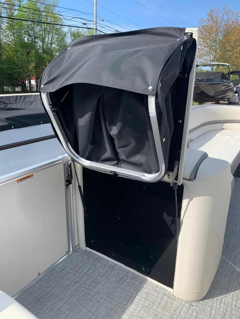 Slide: The Image of 2023 Avalon Catalina VRL 25' Tri-Toon boat interior with black storage compartment. - 26