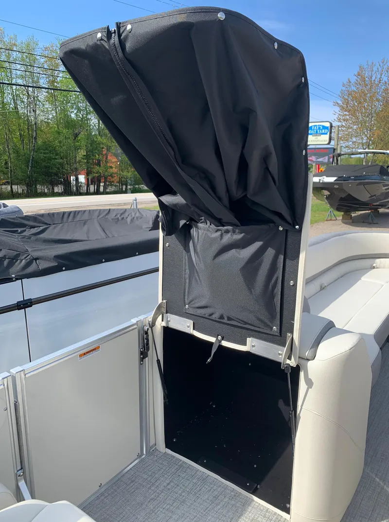 Slide: The Image of 2023 Avalon Catalina VRL 25' Tri-Toon boat with open storage compartment. - 27