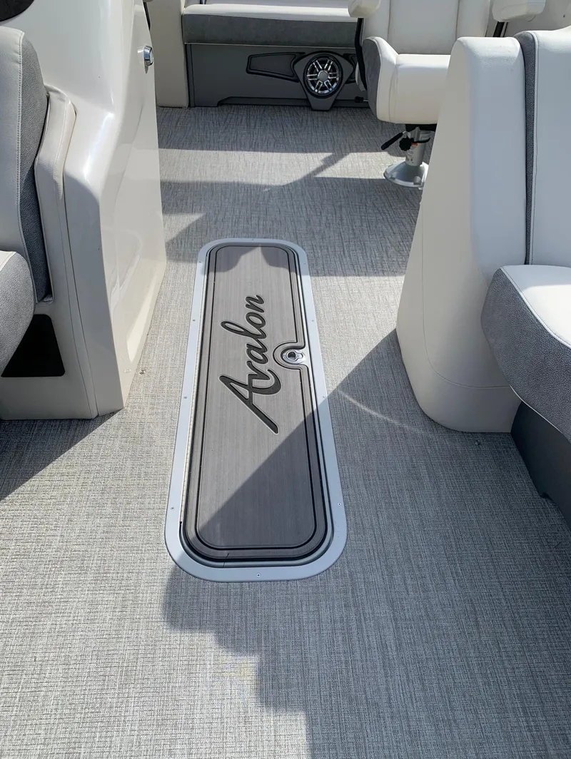 Slide: The Image of 2023 Avalon Catalina VRL 25' Tri-Toon boat interior with Avalon-branded floor compartment. - 29