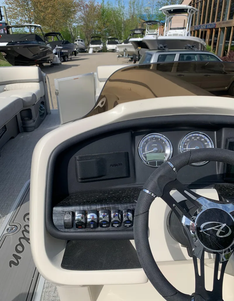 Slide: The Image of 2023 Avalon Catalina VRL 25' Tri-Toon boat dashboard and steering wheel. - 33