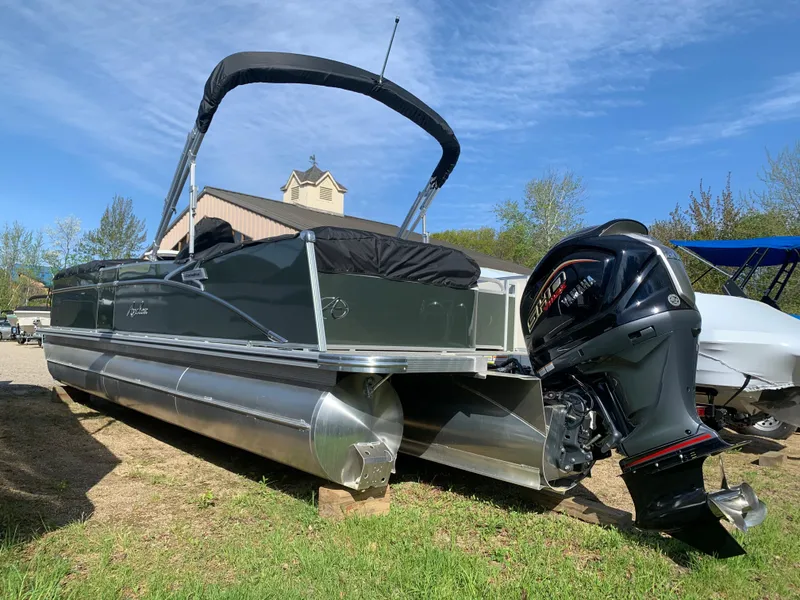 Slide: The Image of 2023 Avalon Catalina VRL 25' Tri-Toon boat with outboard motor on land. - 4