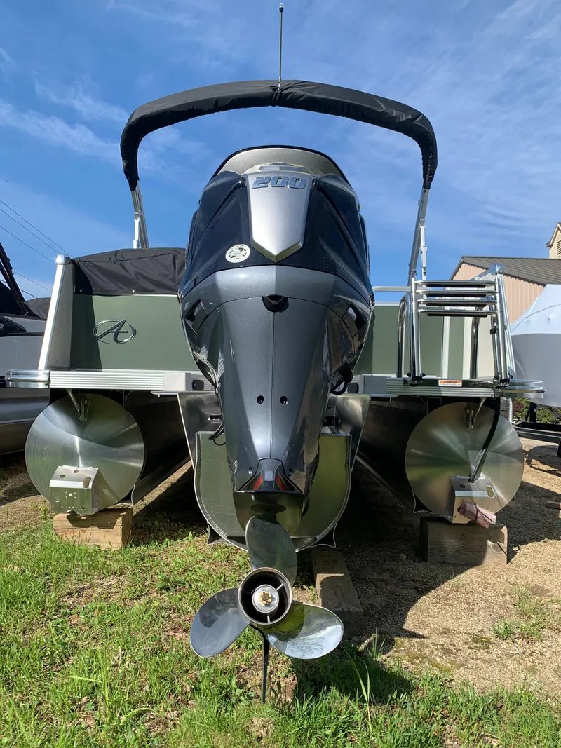 Slide: The Image of 2023 Avalon Catalina VRL 25' Tri-Toon boat with powerful outboard motor. - 5