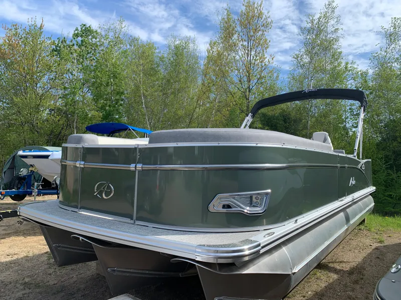 Slide: The Image of 2023 Avalon Catalina VRL 25' Tri-Toon boat in a scenic outdoor setting. - 8