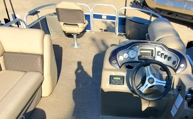 Slide: The Image of 2023 Sun Tracker Party Barge 22 XP3 interior with steering console and seating. - 2