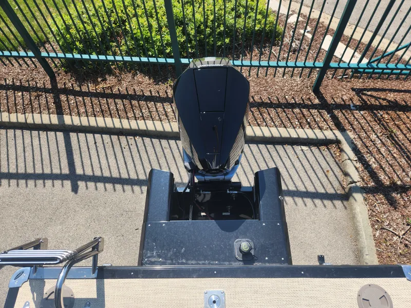 Slide: The Image of Top view of a 2023 Regency 230 LE3 boat engine in a parking area. - 10
