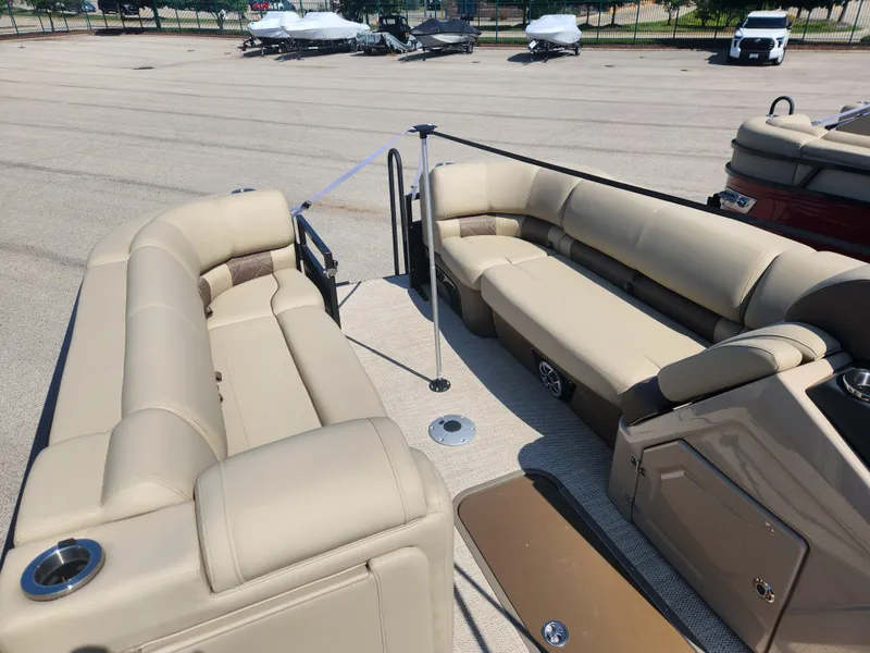 Slide: The Image of 2023 Regency 230 LE3 pontoon boat with beige seating and spacious deck. - 13