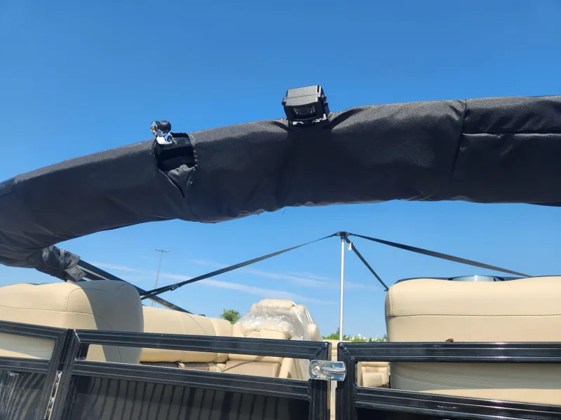 Slide: The Image of 2023 Regency 230 LE3 boat interior with beige seats and black frame. - 14