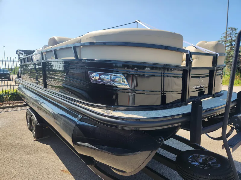 Slide: The Image of 2023 Regency 230 LE3 pontoon boat with sleek black exterior. - 2