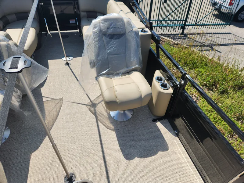 Slide: The Image of 2023 Regency 230 LE3 boat interior with beige seating and cup holders. - 8