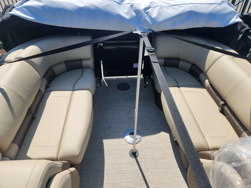 Slide: The Image of 2023 Regency 230 LE3 boat interior with beige seating and carpet. - 9