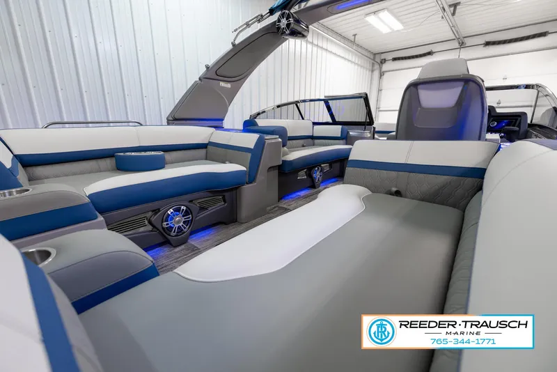 Slide: The Image of 2023 Avalon Waketoon interior with blue and gray seating, showcased by Reeder Trausch Marine. - 14