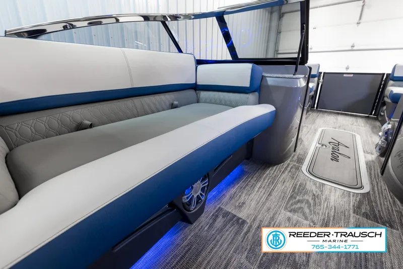 Slide: The Image of 2023 Avalon Waketoon interior with blue LED lighting and Reeder-Trausch Marine branding. - 17