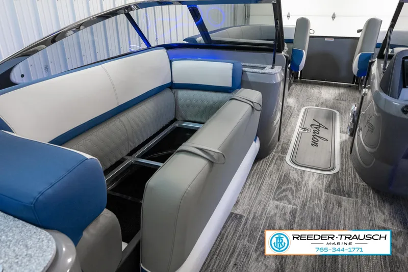 Slide: The Image of 2023 Avalon Waketoon interior with blue and gray seating, Reeder-Trausch Marine logo. - 18