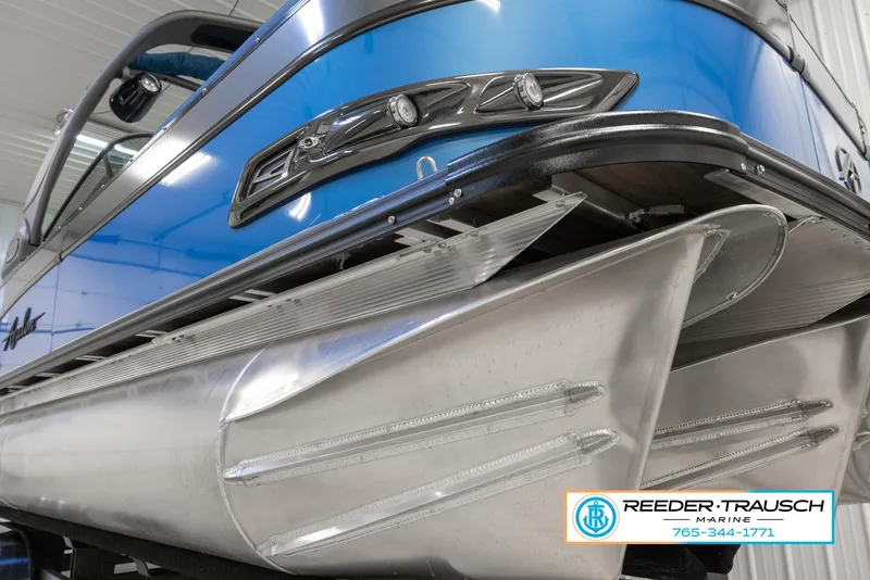 Slide: The Image of 2023 Avalon Waketoon pontoon boat close-up, showcasing sleek design and aluminum pontoons. - 2