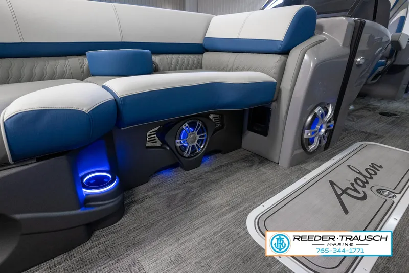 Slide: The Image of 2023 Avalon Waketoon boat interior with blue LED lighting and premium seating. - 23