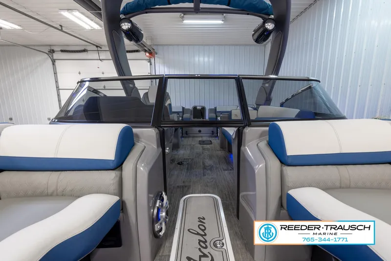 Slide: The Image of 2023 Avalon Waketoon interior view in showroom, Reeder-Trausch Marine logo visible. - 29