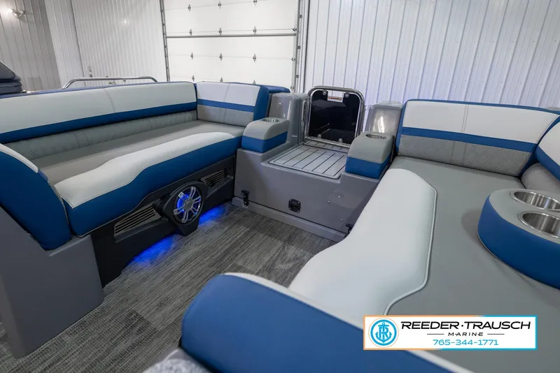 Slide: The Image of 2023 Avalon Waketoon interior with blue and gray seating, Reeder-Trausch Marine logo. - 33