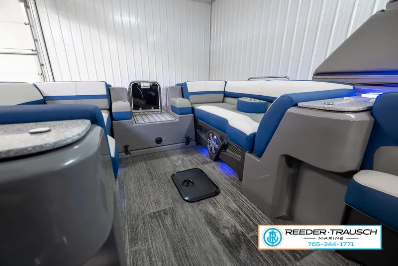 Slide: The Image of Interior of 2023 Avalon Waketoon boat with blue and white seating. - 35