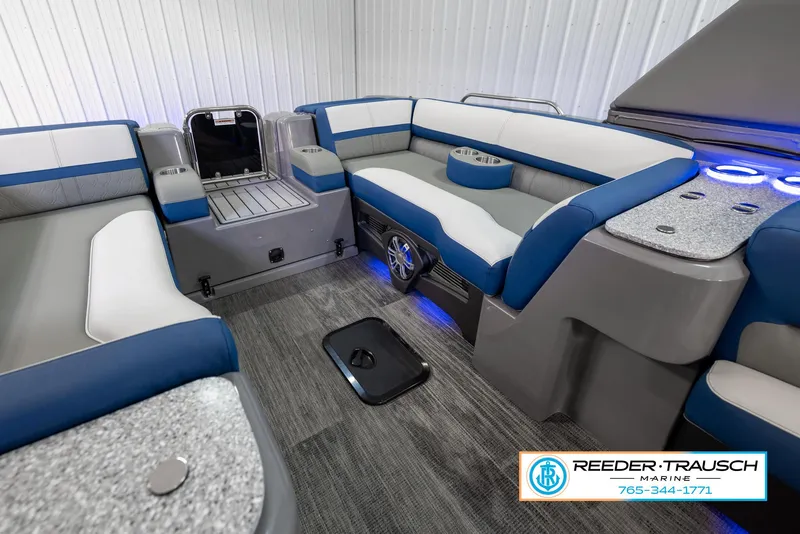 Slide: The Image of 2023 Avalon Waketoon interior with blue and white seating, modern design, and Reeder-Trausch Marine branding. - 36