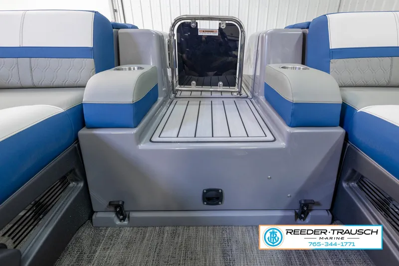 Slide: The Image of 2023 Avalon Waketoon boat interior with blue and gray seating, Reeder-Trausch Marine logo. - 37