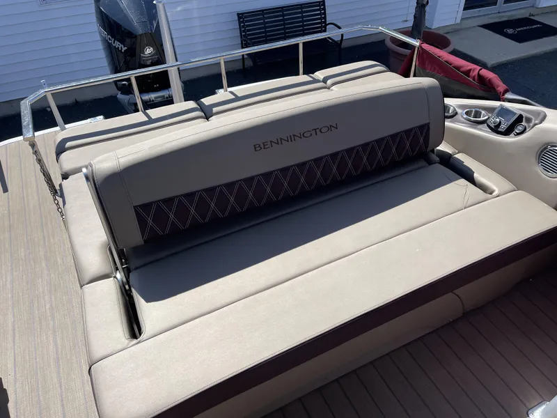 Slide: The Image of 2021 Bennington 24 RTSBA DLX Fold Open SP Arch boat seating area with Mercury engine. - 3