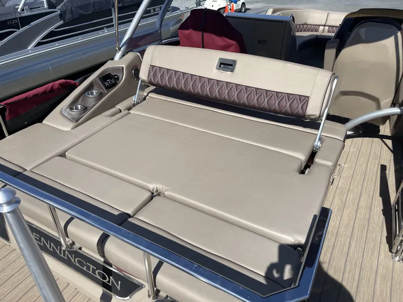 Slide: The Image of 2021 Bennington 24 RTSBA DLX Fold Open SP Arch (Gas Assist) boat interior with beige seating. - 4