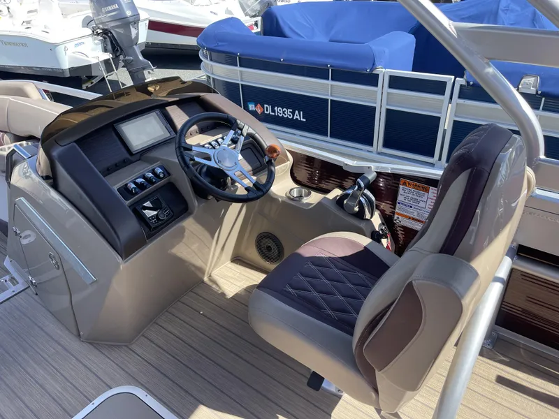 Slide: The Image of 2021 Bennington 24 RTSBA DLX boat cockpit with steering wheel and control panel. - 6