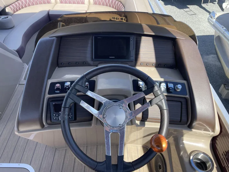 Slide: The Image of 2021 Bennington 24 RTSBA DLX boat dashboard with steering wheel and control panel. - 7