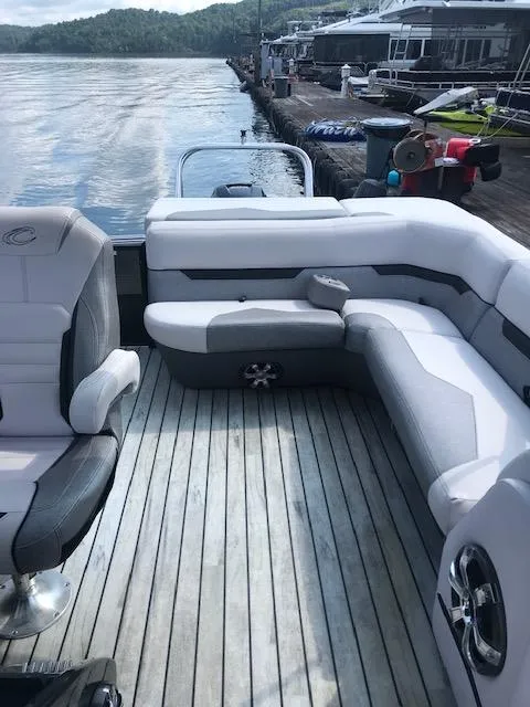 The Image of 2018 Crest Caliber boat with comfortable seating and scenic lake view. - 1