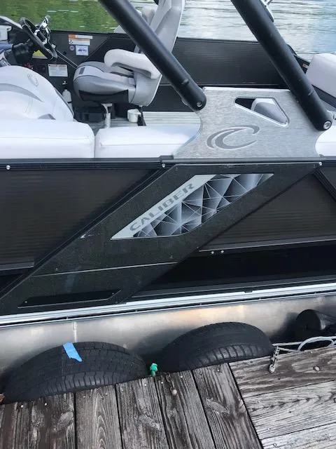 Slide: The Image of 2018 Crest Caliber boat docked with visible interior and exterior details. - 4