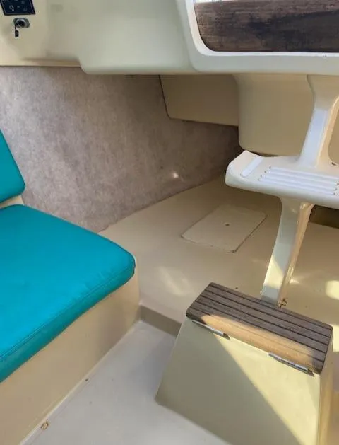 Slide: The Image of Interior of 1993 Hunter 23.5 sailboat with teal seating and beige flooring. - 13