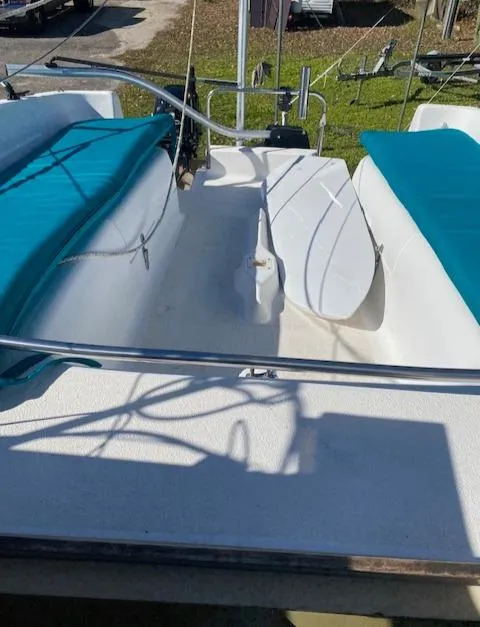 Slide: The Image of 1993 Hunter 23.5 sailboat cockpit with teal cushions and white deck. - 14