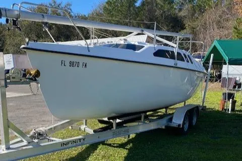 Slide: The Image of 1993 Hunter 23.5 sailboat on trailer, registration FL 9870 FW, parked on grass. - 4