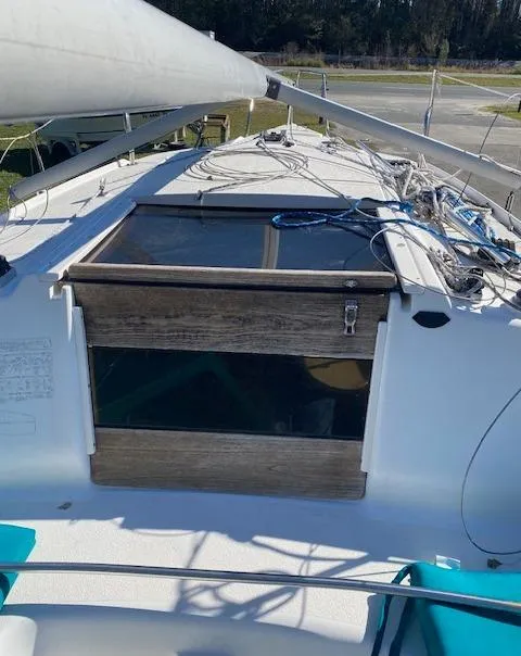 Slide: The Image of 1993 Hunter 23.5 sailboat deck with wooden hatch and rigging. - 6