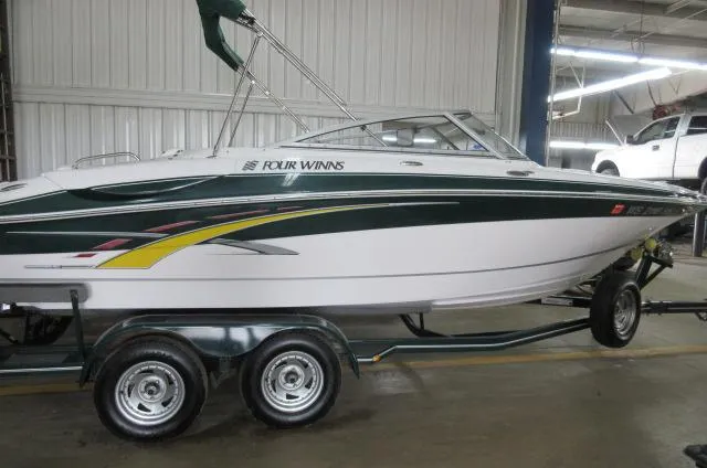 The Image of 2007 Four Winns 220 Horizon boat on a trailer in a garage. - 0