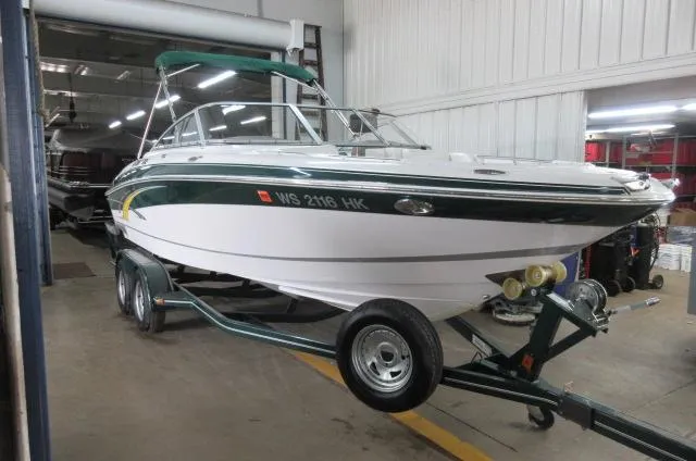 Slide: The Image of 2007 Four Winns 220 Horizon boat on trailer in indoor storage. - 1