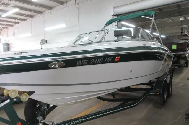 Slide: The Image of 2007 Four Winns 220 Horizon boat on trailer in indoor storage. - 2