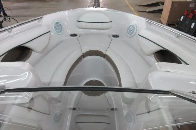 Slide: The Image of 2007 Four Winns 220 Horizon boat interior with white seating and built-in speakers. - 6