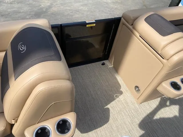 Slide: The Image of 2023 Barletta Cabrio C22U interior with beige and black seating, cup holders, and flooring. - 12