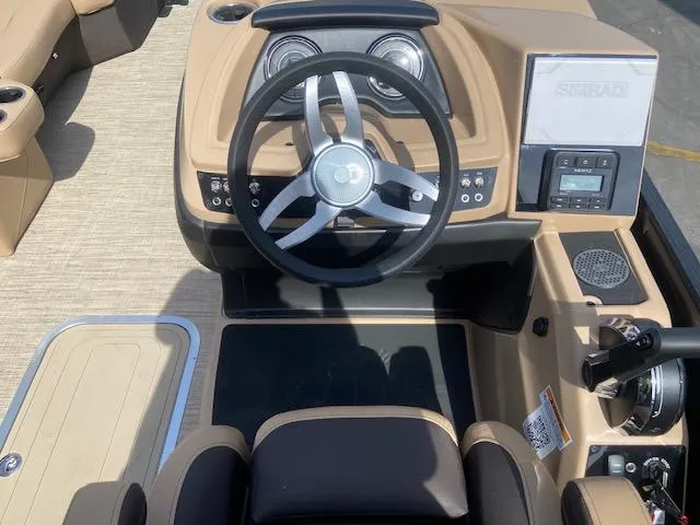 Slide: The Image of 2023 Barletta Cabrio C22U boat dashboard with steering wheel and control panel. - 13