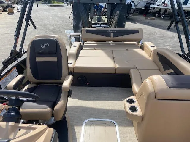 Slide: The Image of 2023 Barletta Cabrio C22U pontoon boat interior with tan and black seating. - 15