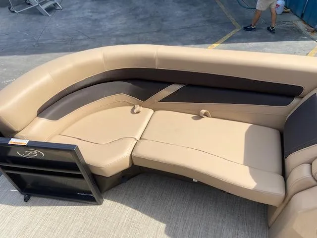Slide: The Image of 2023 Barletta Cabrio C22U boat interior with beige and brown seating. - 17