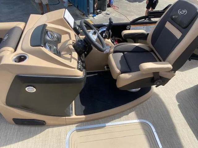 Slide: The Image of 2023 Barletta Cabrio C22U boat helm with beige and black captain's chair. - 20
