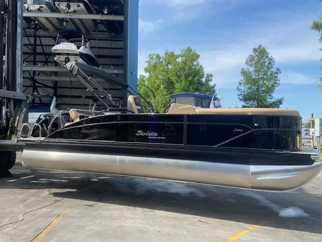 Slide: The Image of 2023 Barletta Cabrio C22U pontoon boat in a marina. - 21