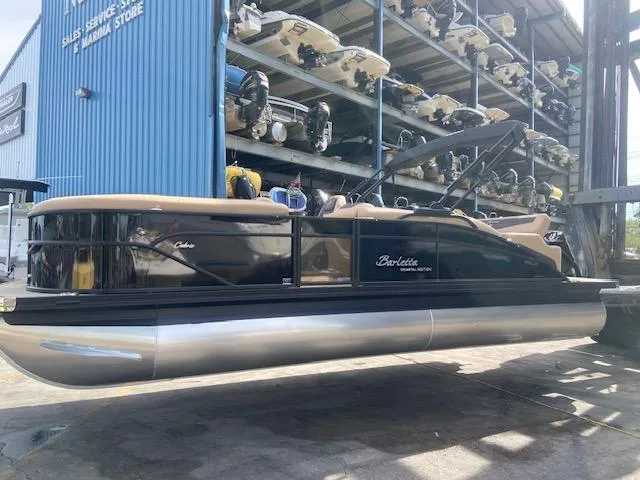Slide: The Image of 2023 Barletta Cabrio C22U pontoon boat at a marina storage facility. - 22