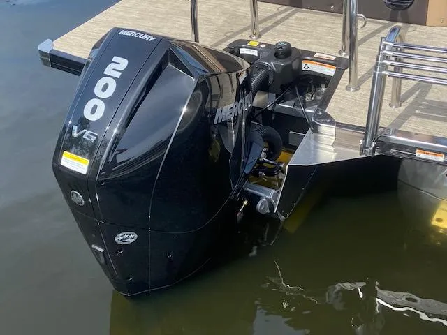 Slide: The Image of 2023 Barletta Cabrio C22U with Mercury 200 V6 outboard motor in water. - 23