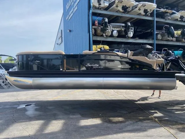 Slide: The Image of 2023 Barletta Cabrio C22U pontoon boat at a marina storage facility. - 6