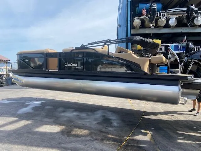 Slide: The Image of 2023 Barletta Cabrio C22U pontoon boat on a dock, ready for launch. - 7